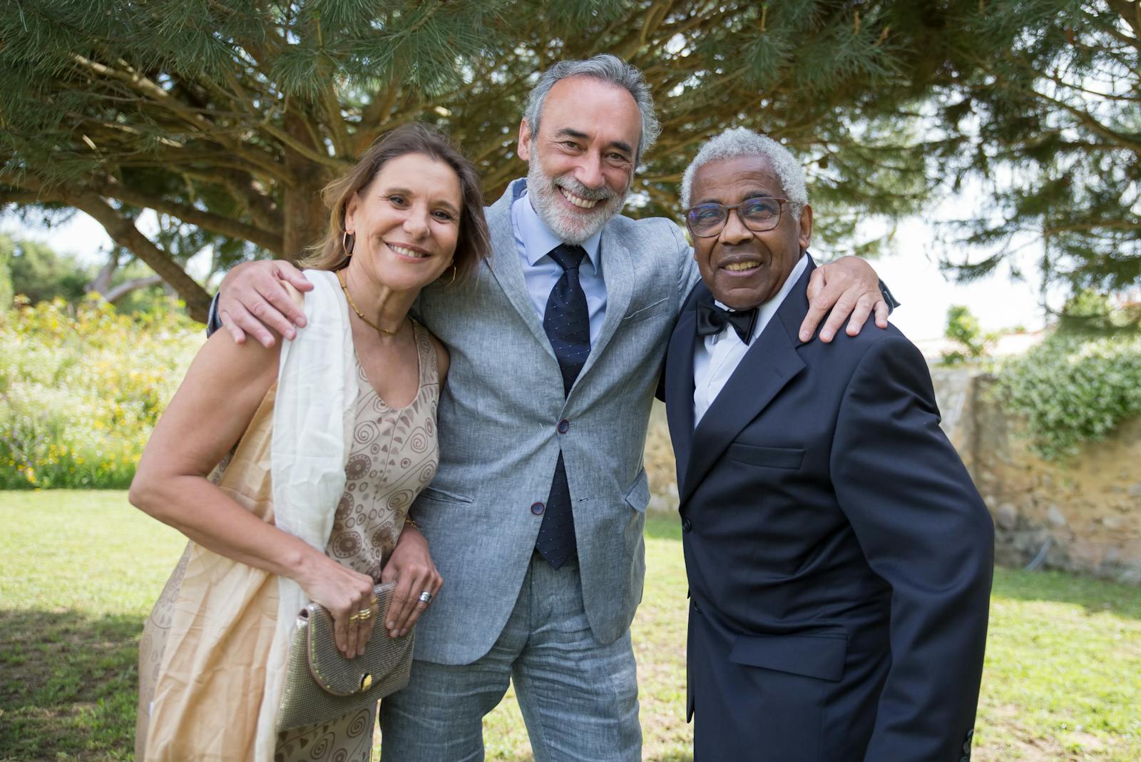 Happy senior friends posing together outdoors on a sunny day in Portugal.